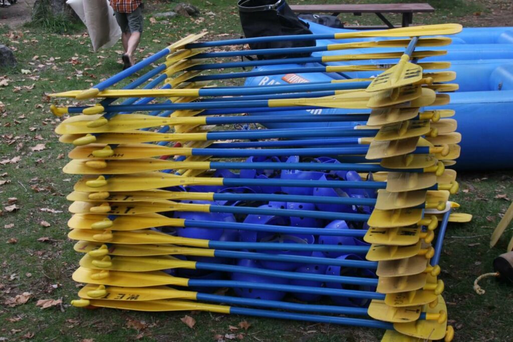 Paddles and helmets stacked ready for a day of rafting